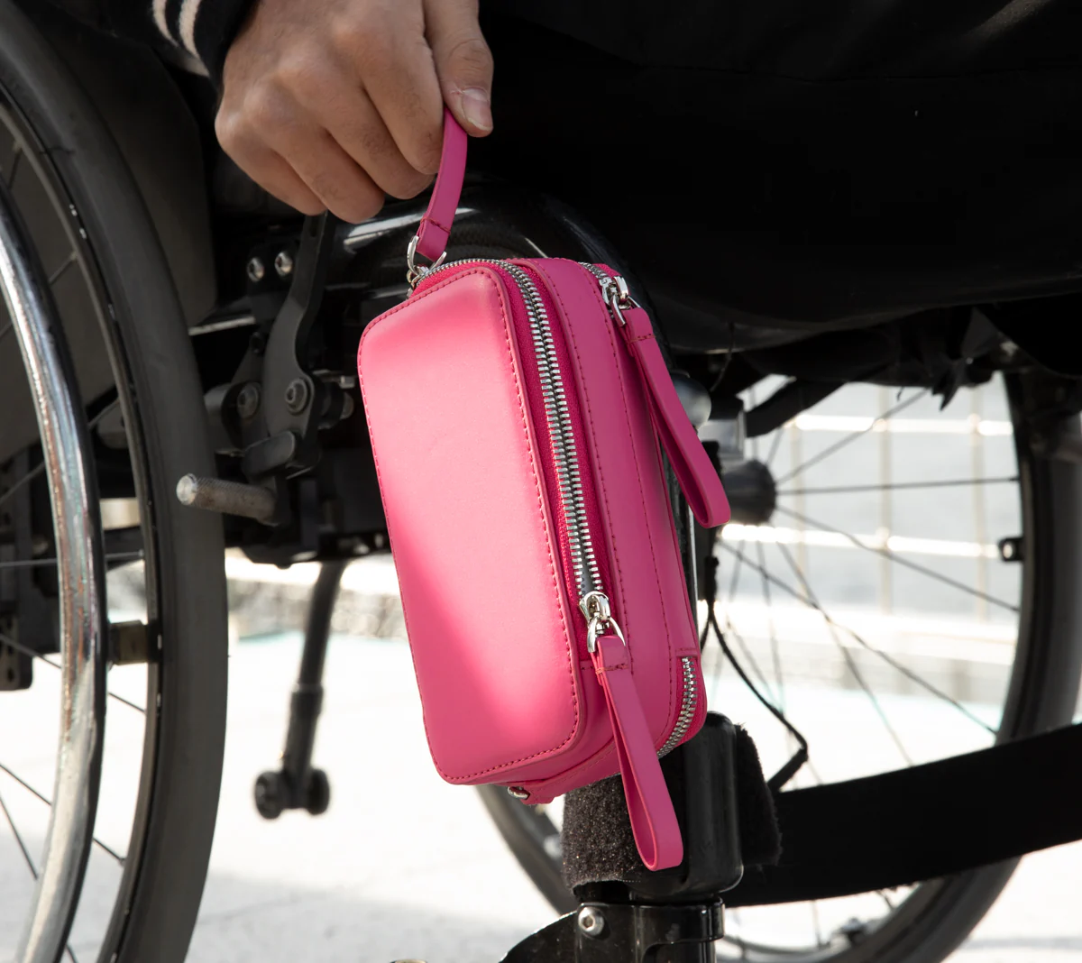 Pink bag show at side of wheelchair